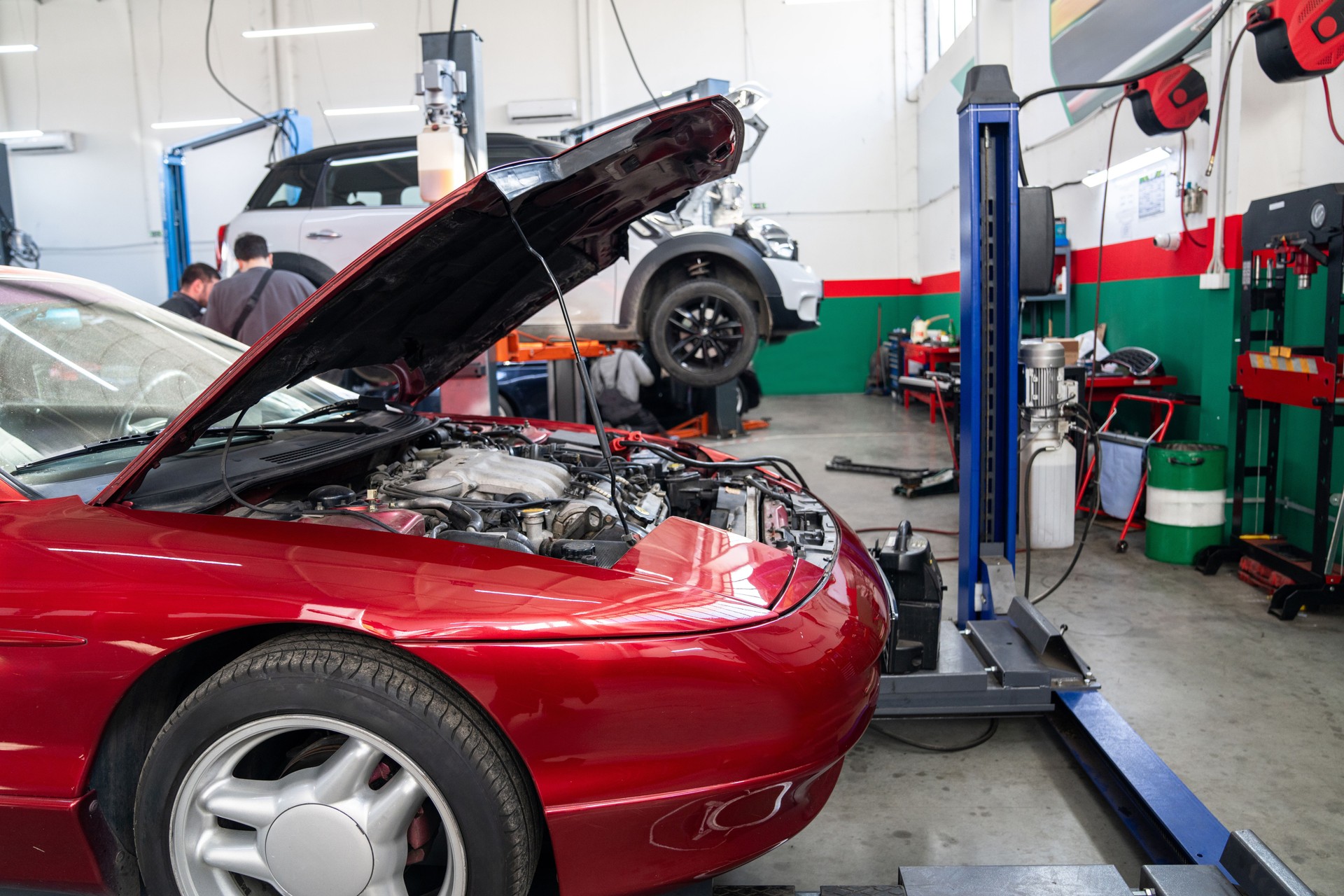 Car service workshop with cars on a column lifts