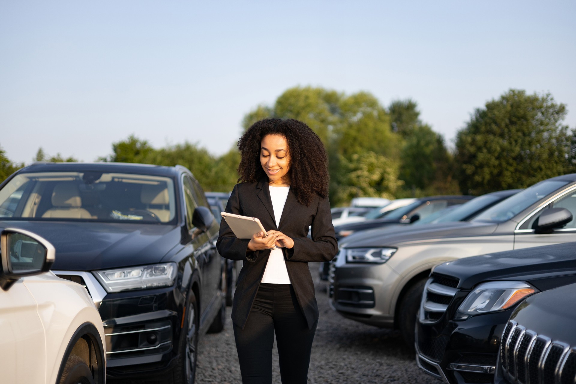 Woman in Dealership with Tablet