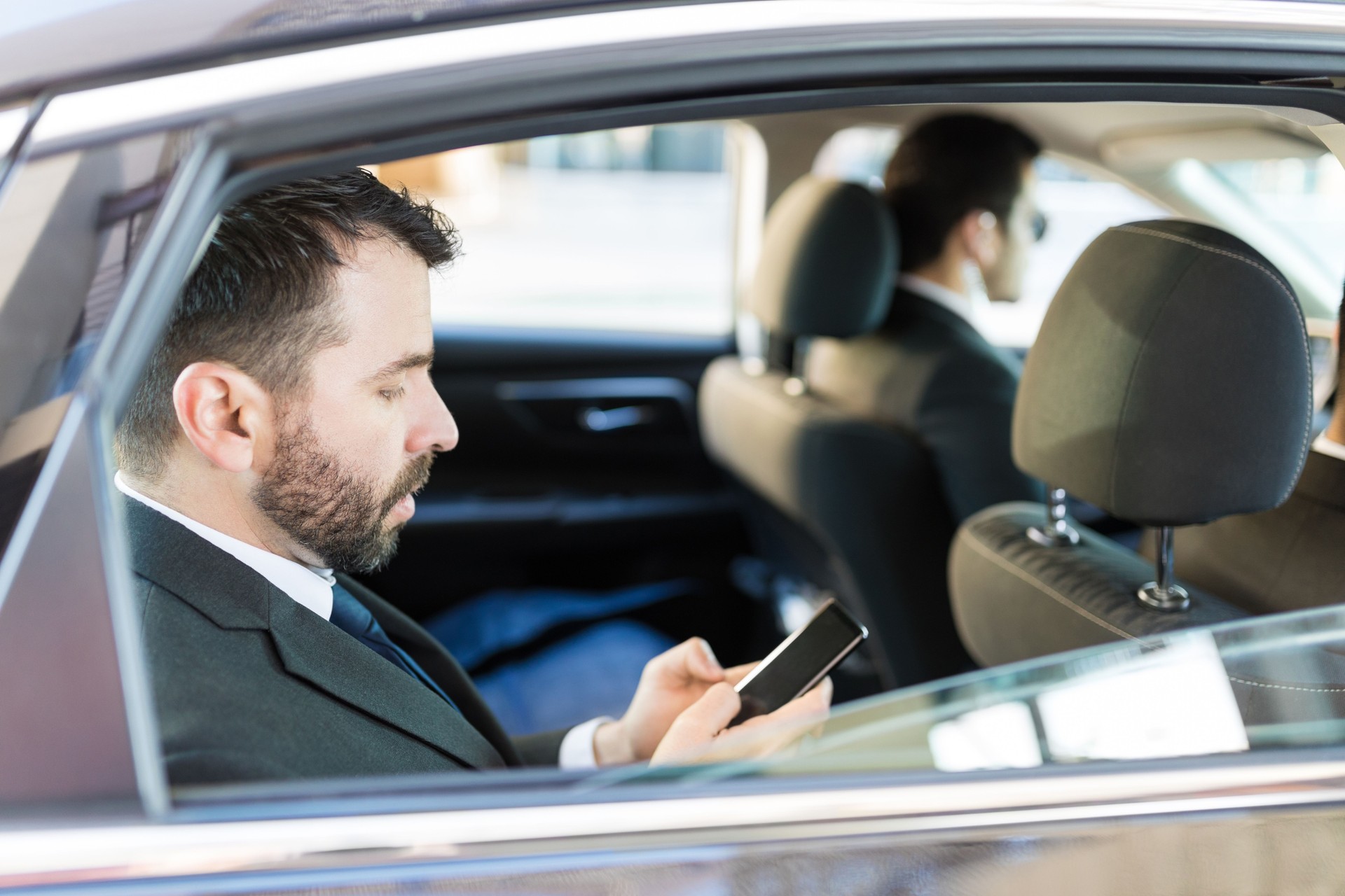 Entrepreneur Checking Phone In Car